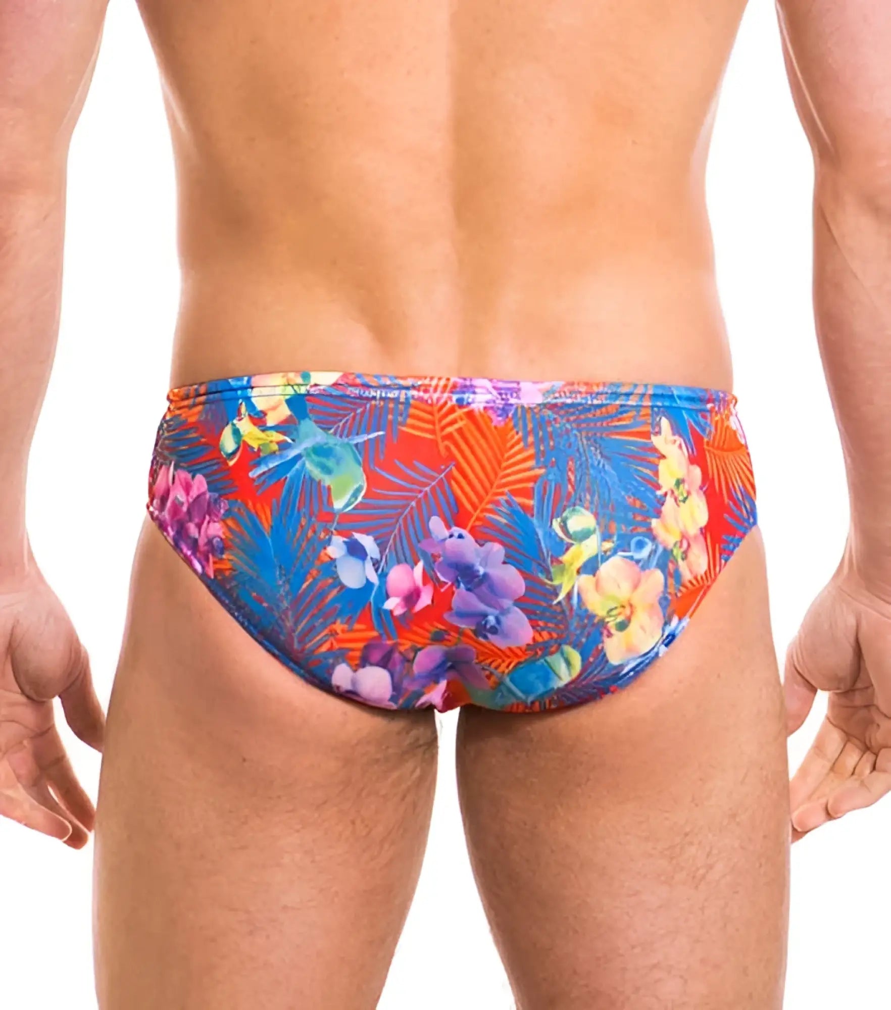 Vibrant tropical floral patterned kiniki continental tan through deep waist bikini swim trunks in red blue and purple hues