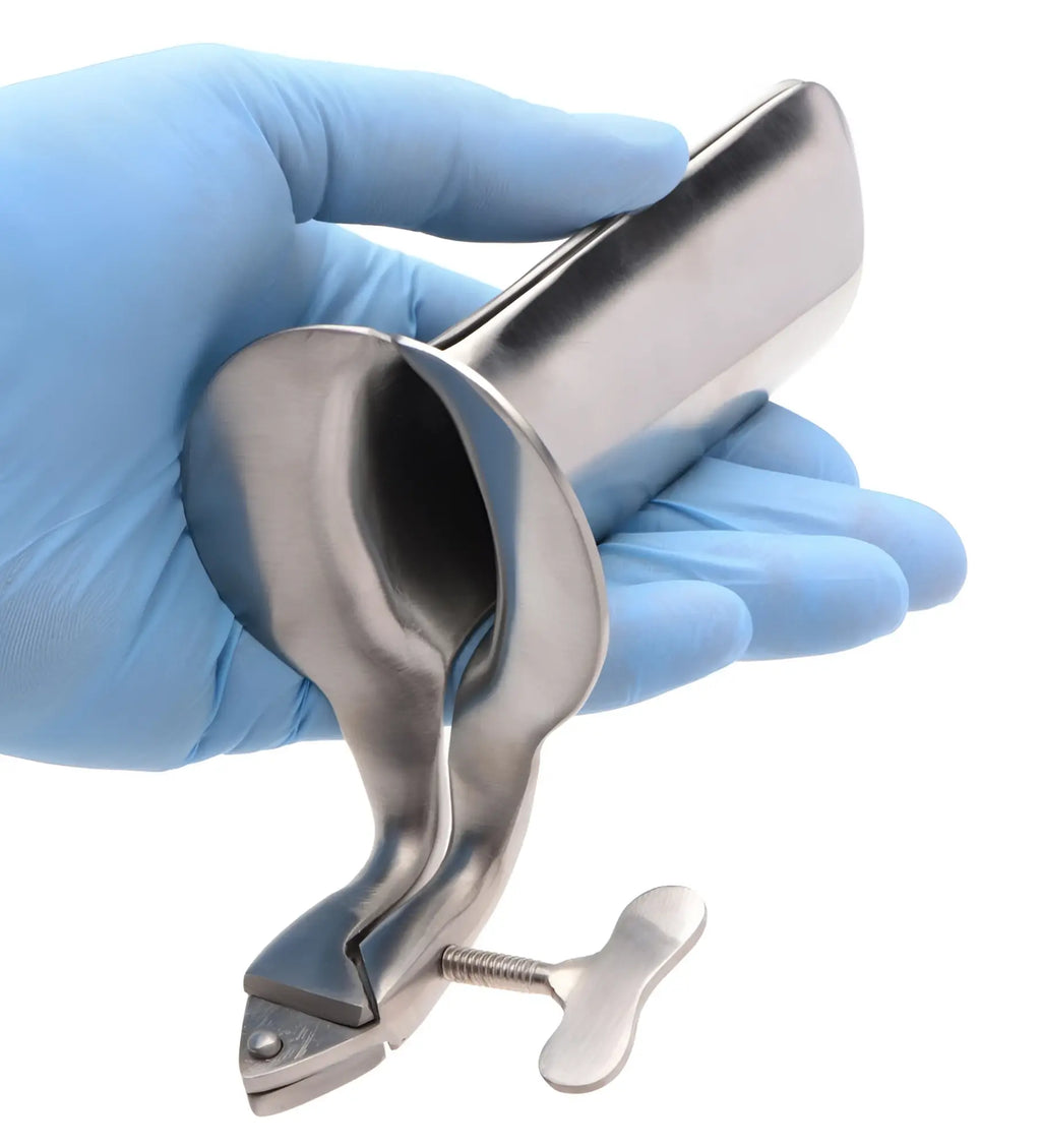 A hand in a blue medical glove holds a stainless steel Kink Industries Collins speculum with a manual adjustment screw.