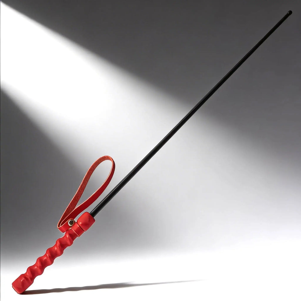 Kink Industries The Intense Impact Cane features a long, thin black shaft with a vibrant red, textured grip and loop.