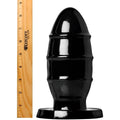 Kink Industries PVC Missile butt plug in shiny black, shown with a wooden ruler for scale on a white background.