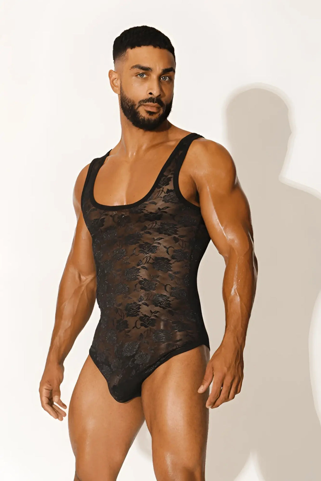 Black lace kiss-it-better bodysuit with floral pattern featuring sheer delicate fabric and elegant design