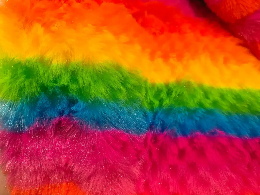 Rainbow stripe faux fur hoodie featuring vibrant rainbow-colored fluffy fabric with red orange yellow green blue pink stripes