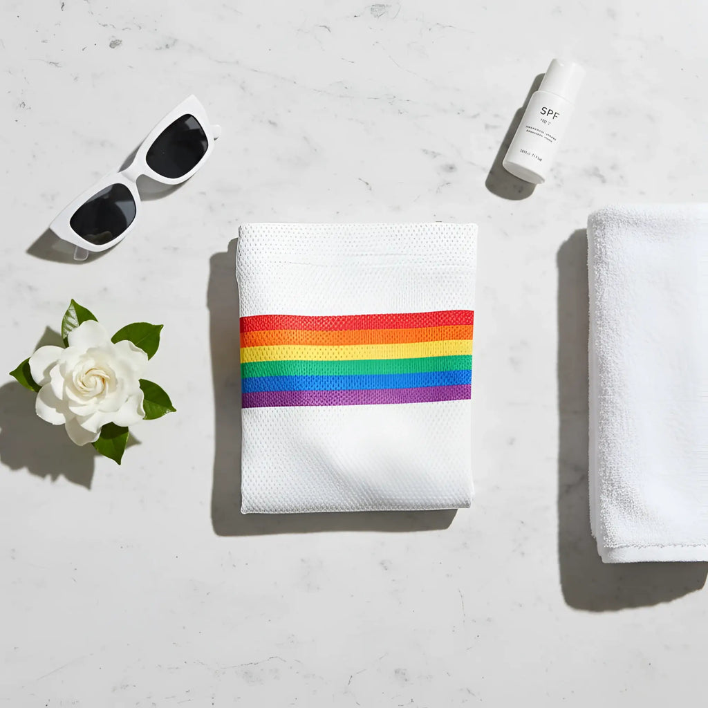White towel featuring a horizontal rainbow stripe design matching knobs sf rainbow stripe mesh shorts in white