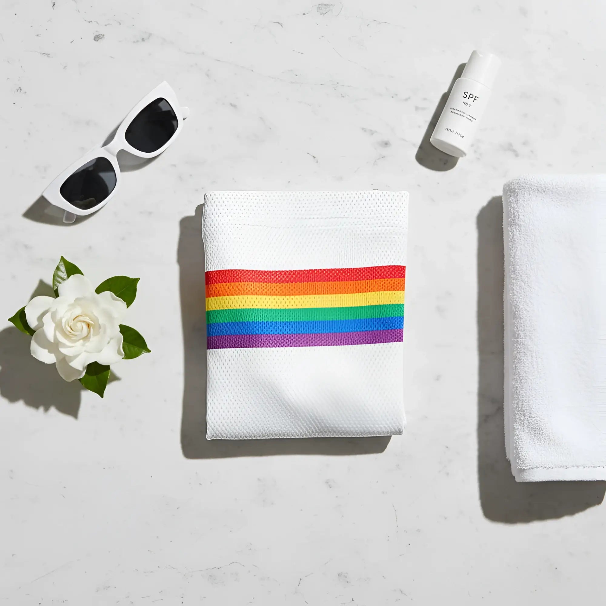 White towel featuring a horizontal rainbow stripe design matching knobs sf rainbow stripe mesh shorts in white