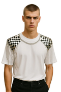 White t-shirt with black and silver checkered shoulder panels and dangling chains styled as shoulder tassel necklace