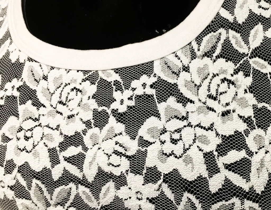 Lace tee with white floral lace top over black base and clean white rounded neckline for casual wear