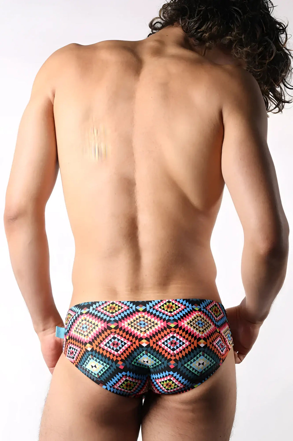 Lakeshore low-rise swim brief featuring vibrant geometric diamond patterns in bold pink blue and teal for men
