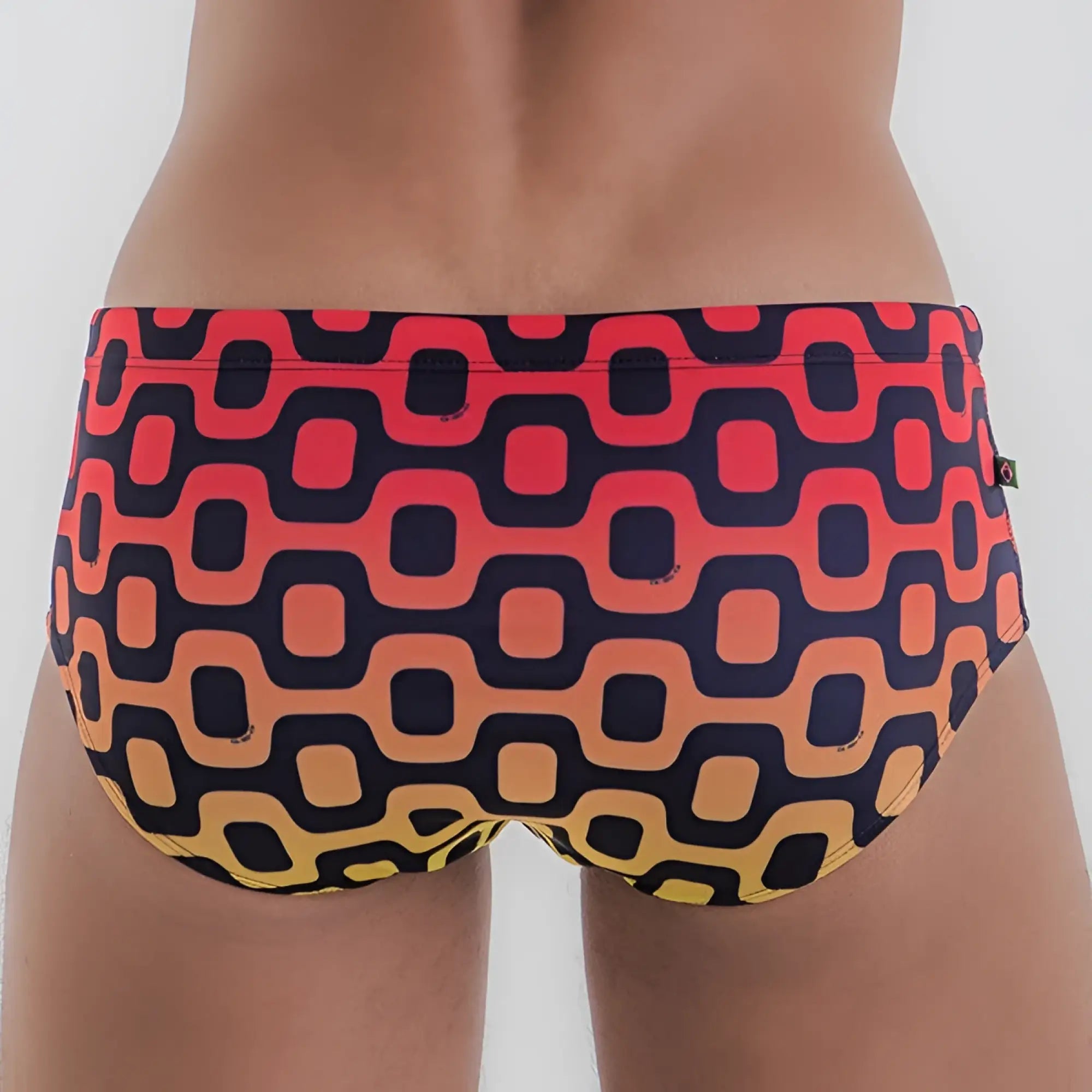Leblon sunga men’s designer swimwear featuring vibrant geometric patterned swim trunks in red orange and yellow gradient