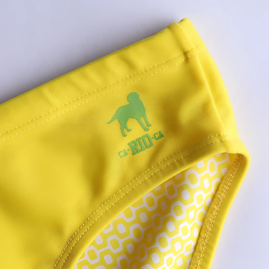 Lemonade yellow solid men’s swimming sunga with lime green dog logo and inner white yellow geometric lining