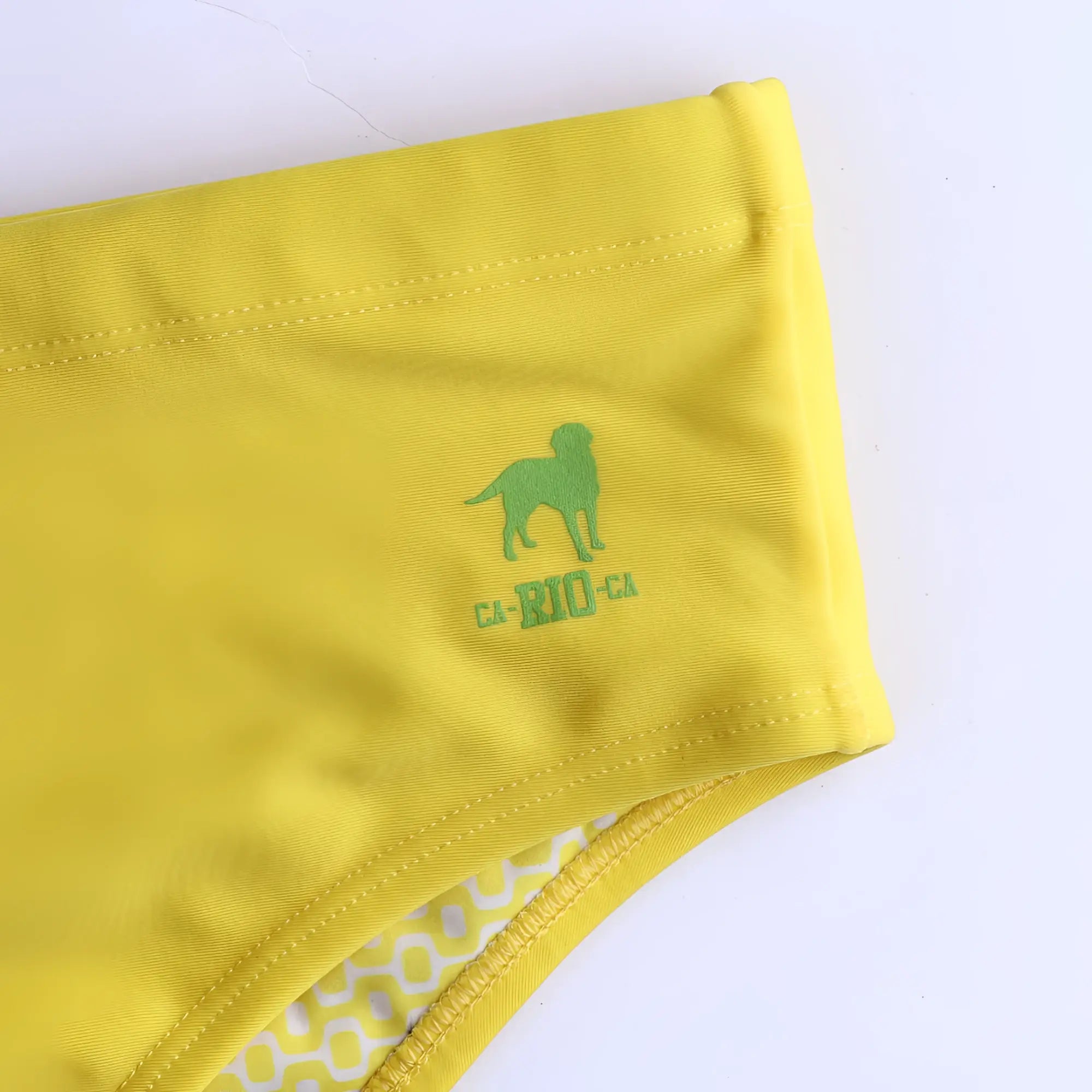 Lemonade yellow solid men’s swimming sunga with green dog logo and ca-rio text embroidered on waistband for beachwear