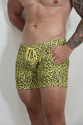 Bright yellow leopard fleece shorts with matching drawstring waistband in a vibrant swim trunk style