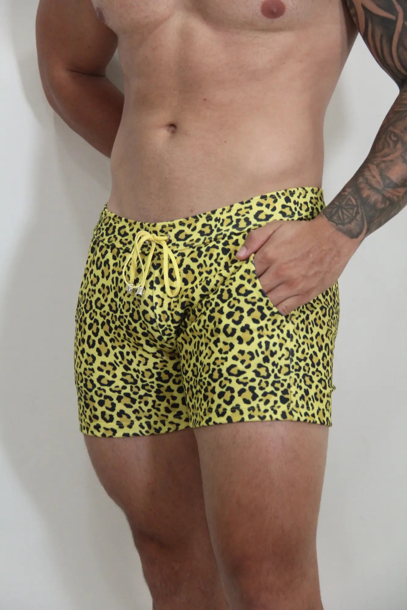 Bright yellow leopard fleece shorts with matching drawstring waistband in a vibrant swim trunk style