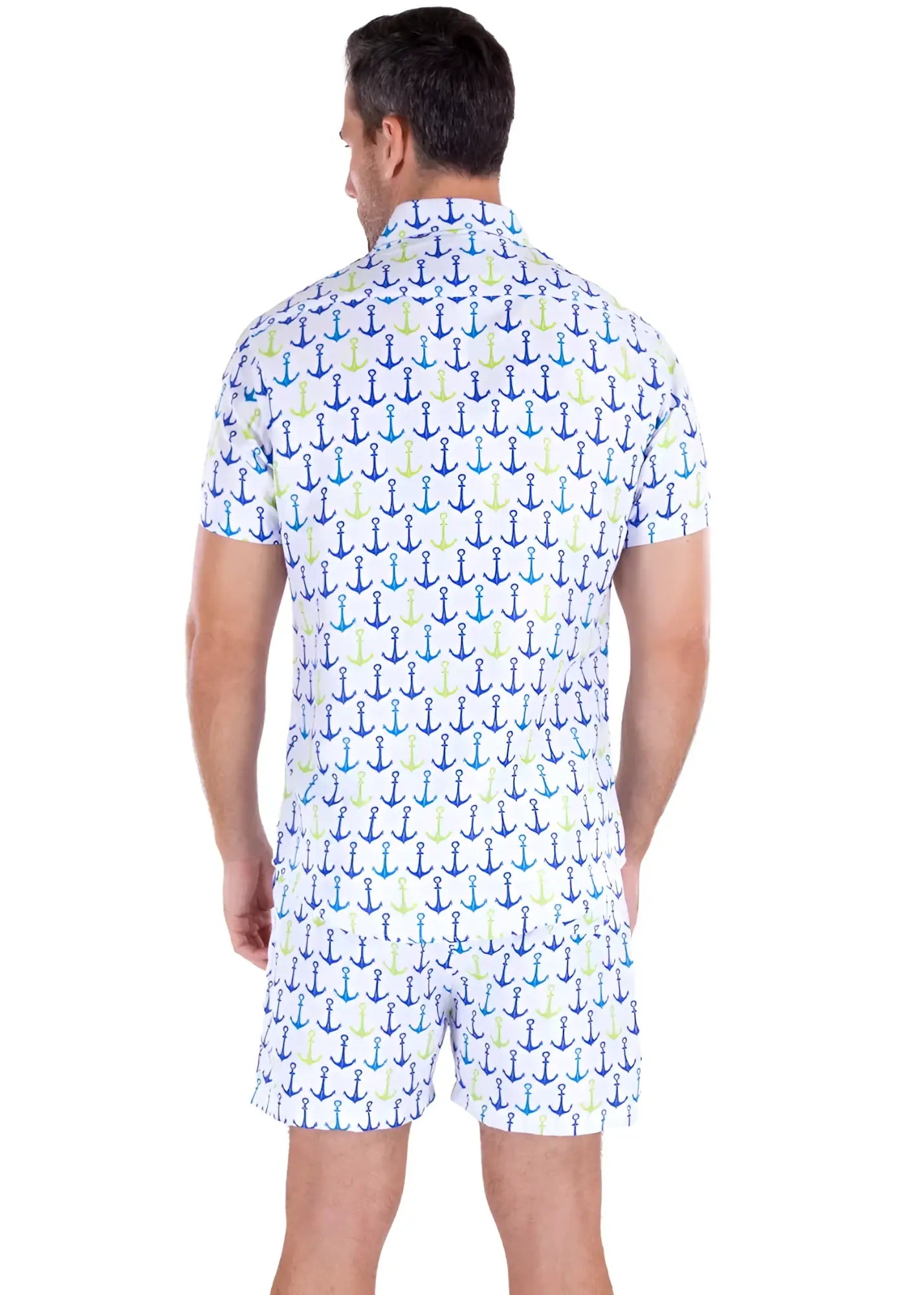 A man wearing a white life’s better on a boat s/s shirt and shorts with blue teal and light green anchor patterns