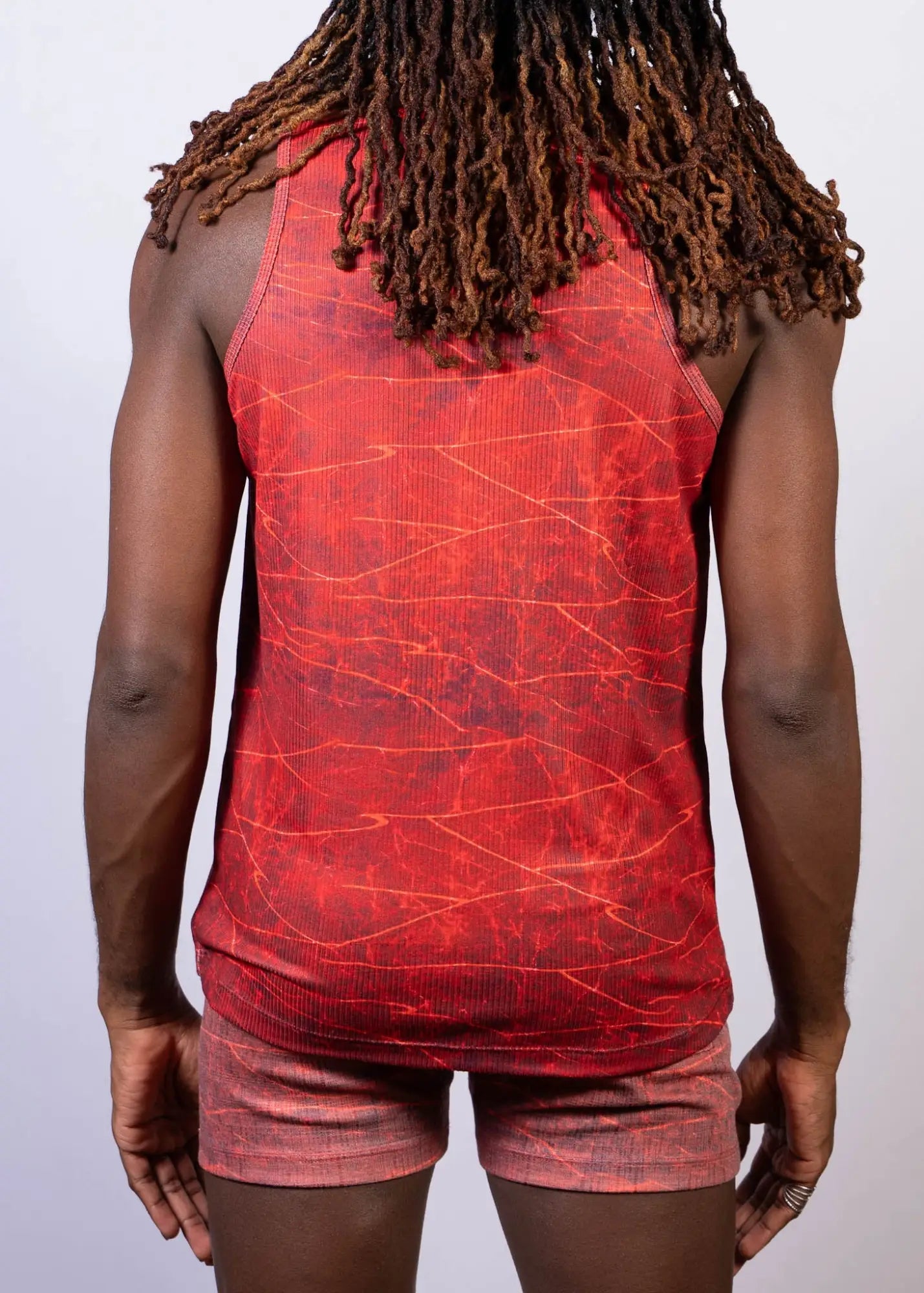 Red tank top with cracked marble pattern in darker red and orange hues from the lightning print tank collection