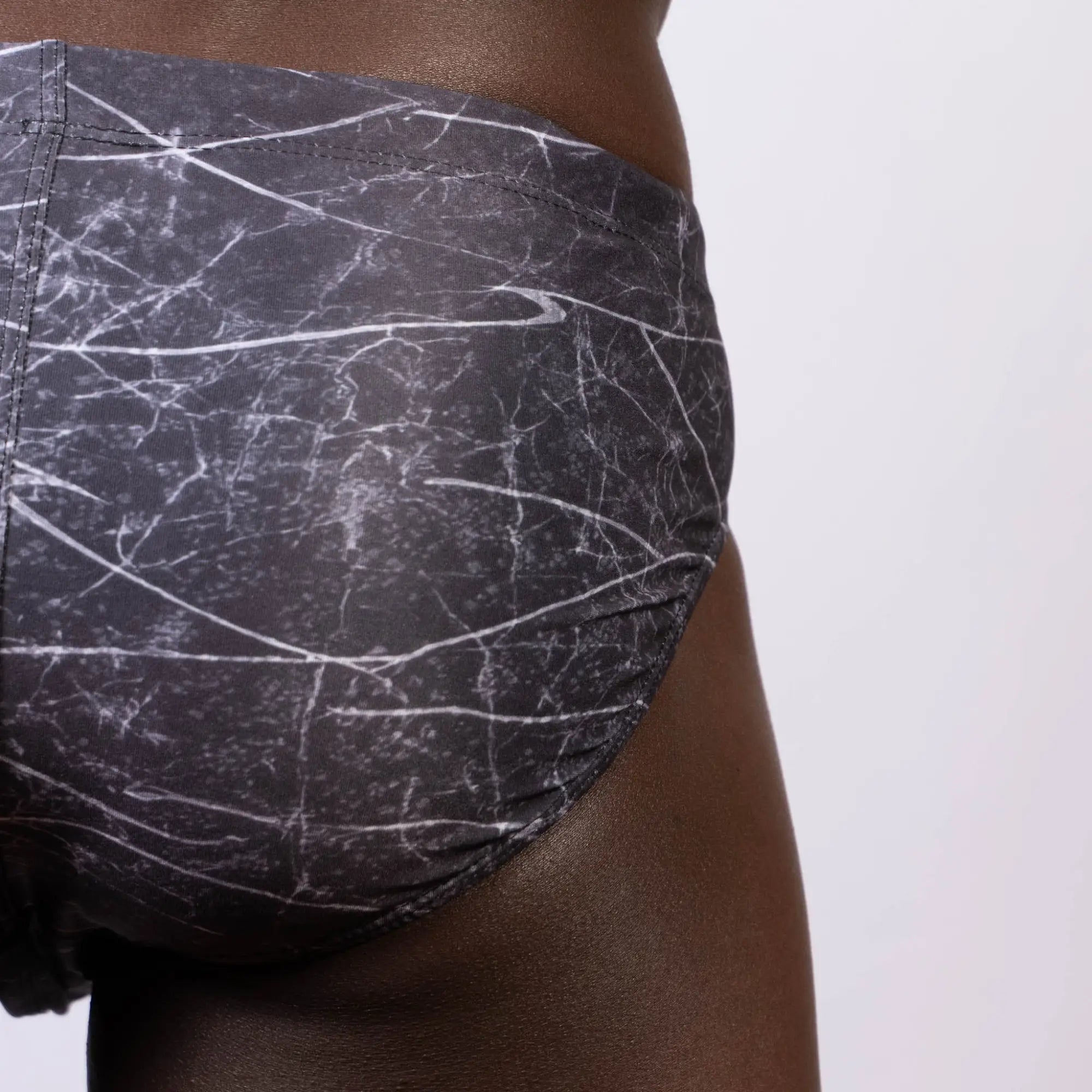 Black and white marble patterned nike lightning swim brief with subtle swoosh logo for men
