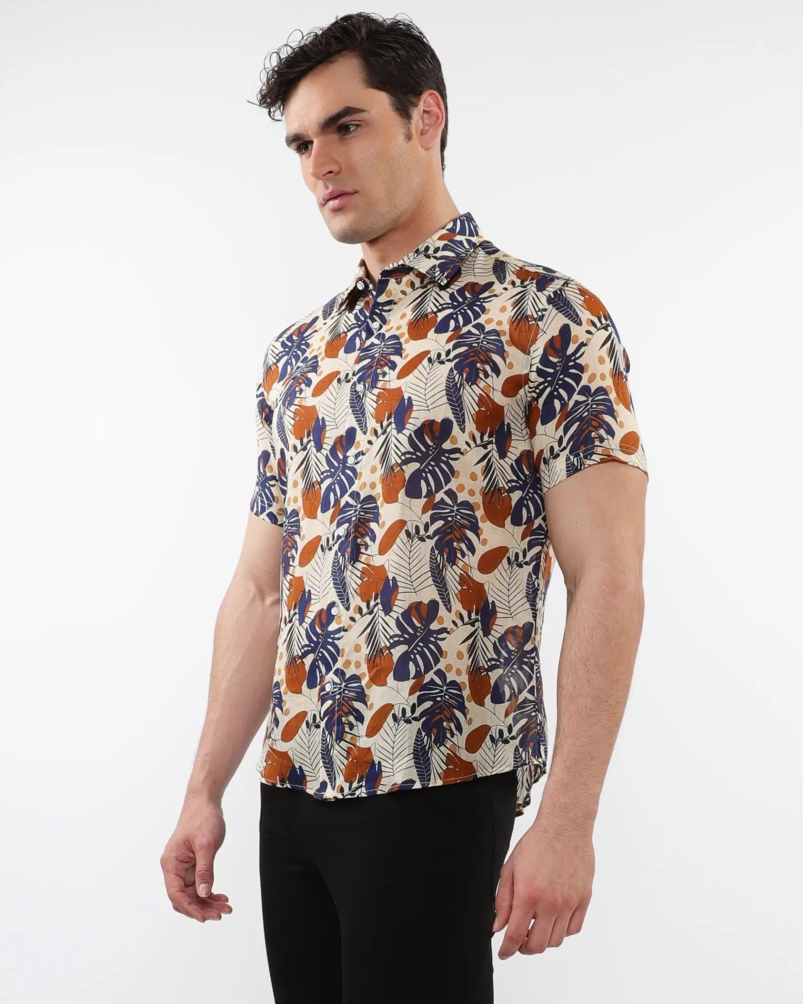 Lightweight linen tencel short-sleeved shirt with vibrant navy blue burnt orange tropical leaf pattern on beige fabric