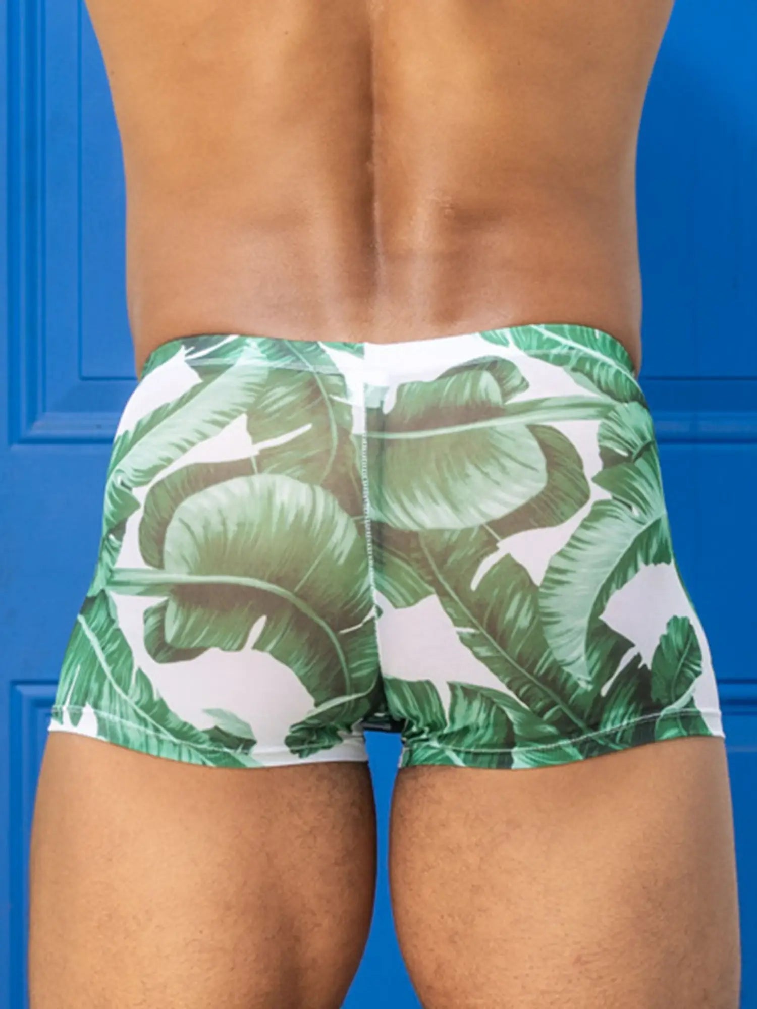 Little boy blue design chris square cut green banana leaf patterned mesh swim trunks on white background