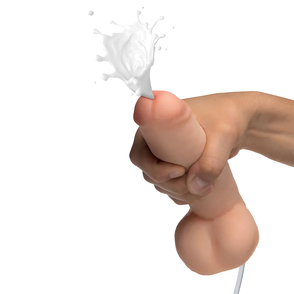 Loadz 8-inch realistic, dual-density skin-tone dildo held in a hand, spraying white liquid from the tip.