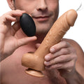 Loadz 8-inch realistic skin-tone vibrating squirting dildo with a black remote control held by a man.