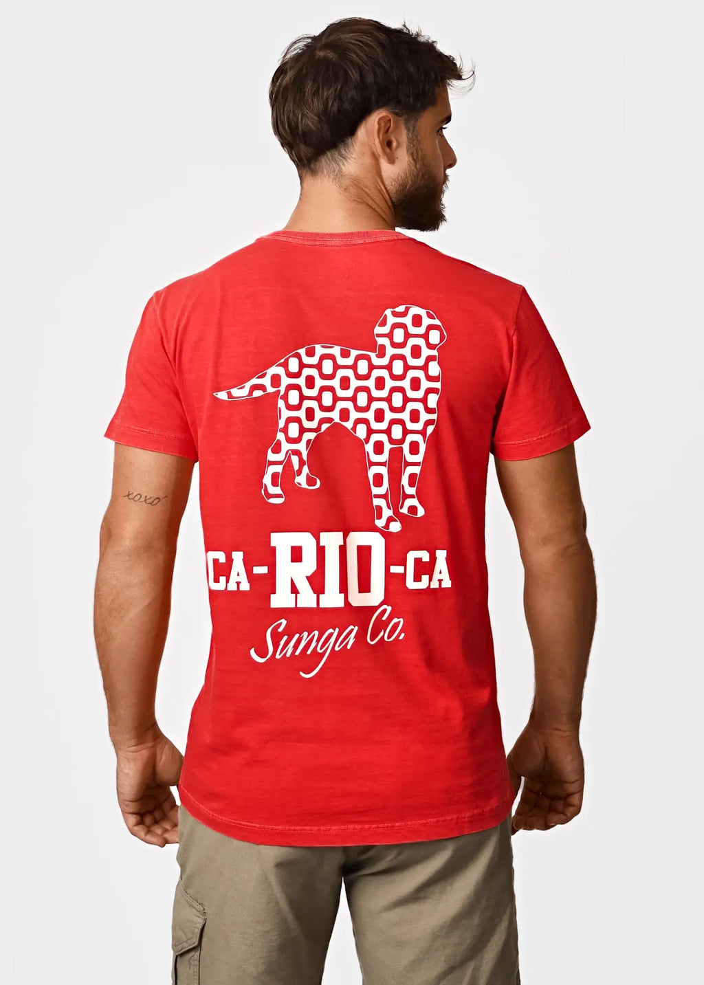 Back of red men’s short-sleeved t-shirt with white geometric dog silhouette and ca-rio-ca sunga co text