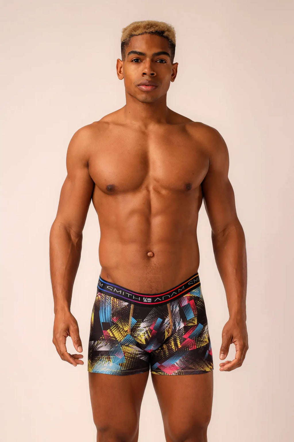 Long trunks men’s boxer briefs with multicolored geometric patterns on black base and vibrant blue yellow pink accents