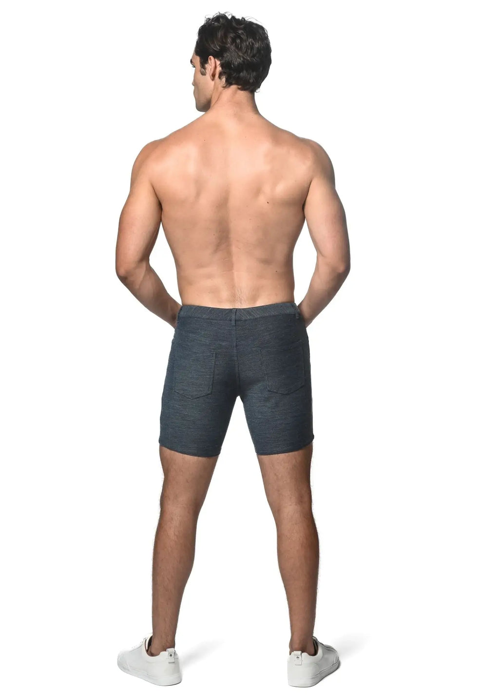 Dark blue loopback stretch knit shorts with a classic fit and two rear pockets shown from the back side