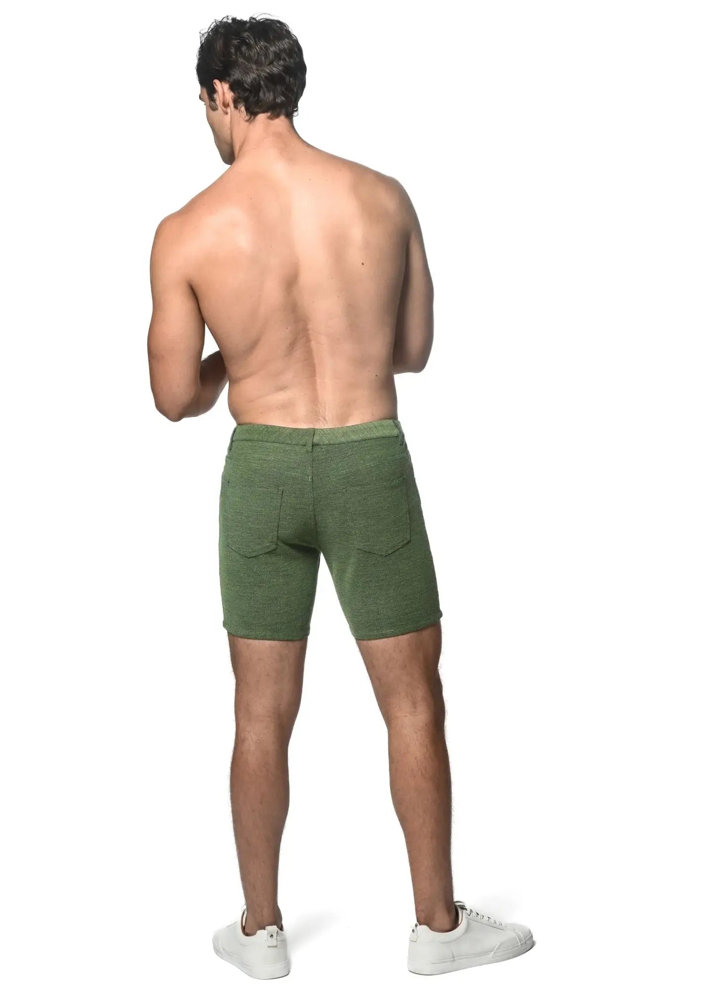 Olive green loopback stretch knit shorts with textured fabric and rear pockets shown from the back side