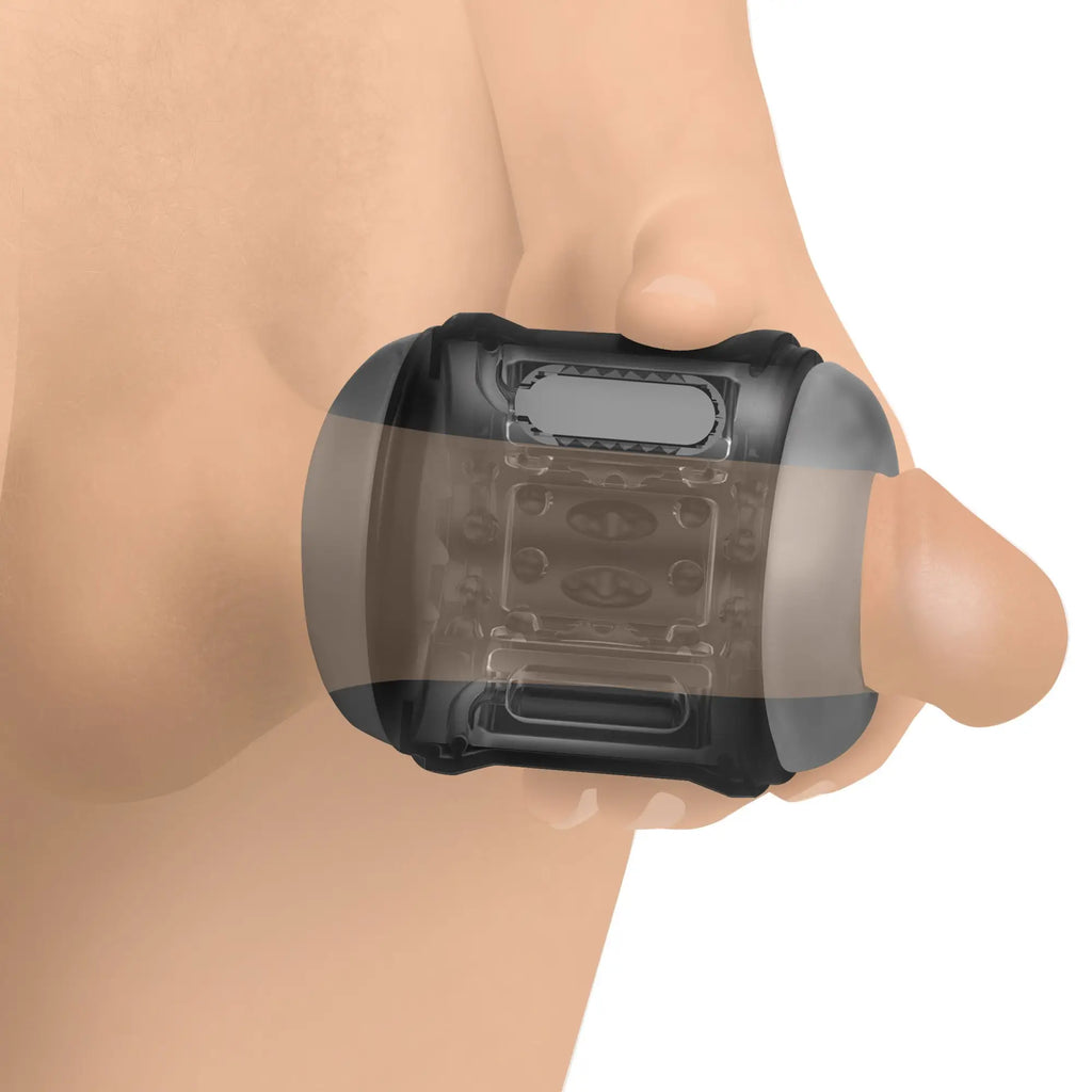 LoveBotz 10X Cyber Stroke: a translucent black, handheld textured vibrating masturbator being held by a hand.