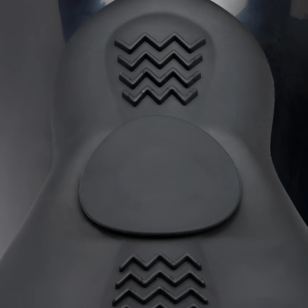 LoveBotz The Bucking Saddle: A black, ergonomic silicone seat with textured zigzag grip pads on a smooth surface.