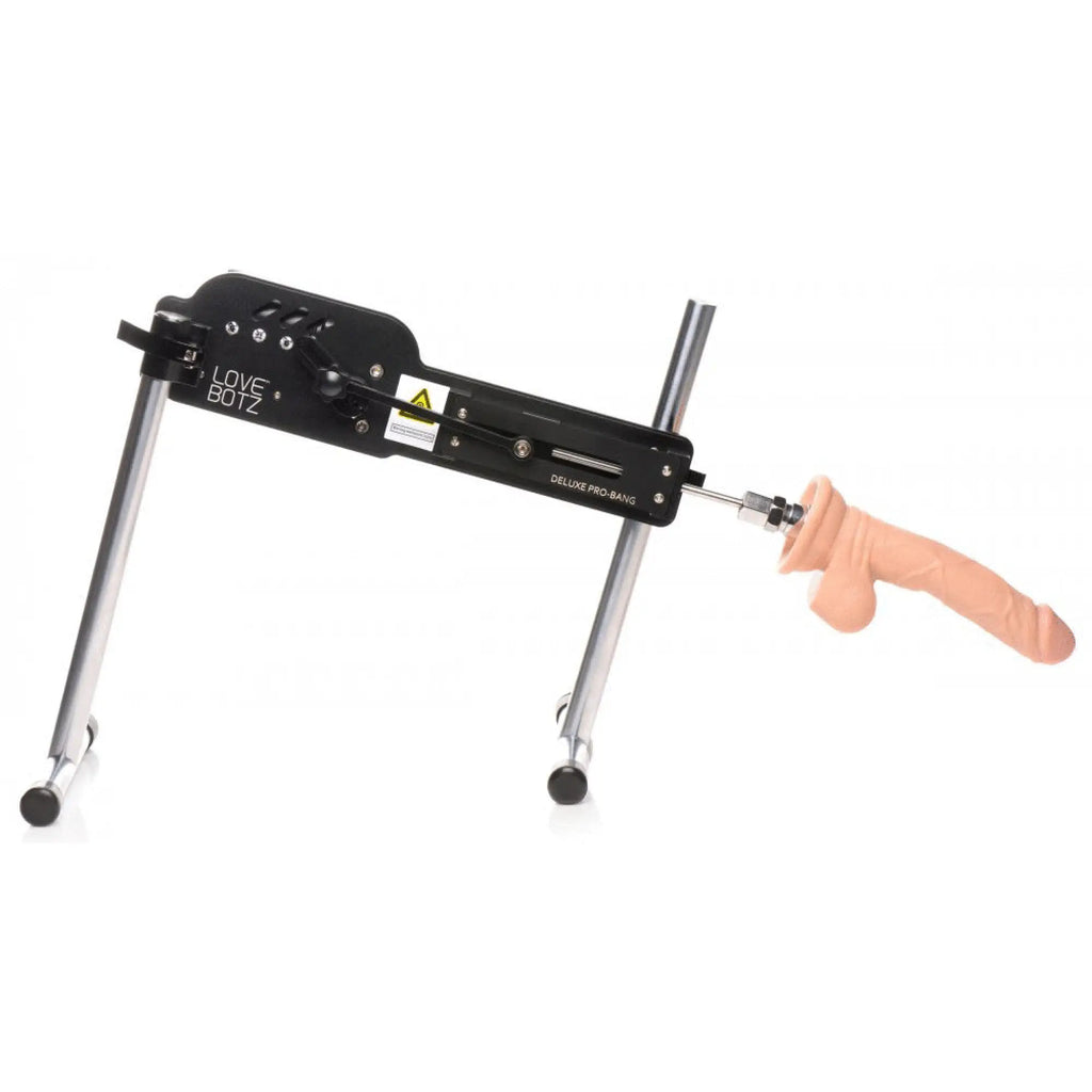 LoveBotz Deluxe Pro-Bang sex machine featuring a black metal frame, silver support legs, and a tan silicone attachment.
