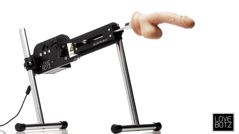 LoveBotz Deluxe Pro-Bang machine: black metal frame with a skin-toned silicone attachment, viewed against white.