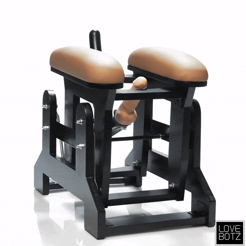 LoveBotz Love Glider machine in black with tan pads and a center phallic attachment, isolated on a white background.