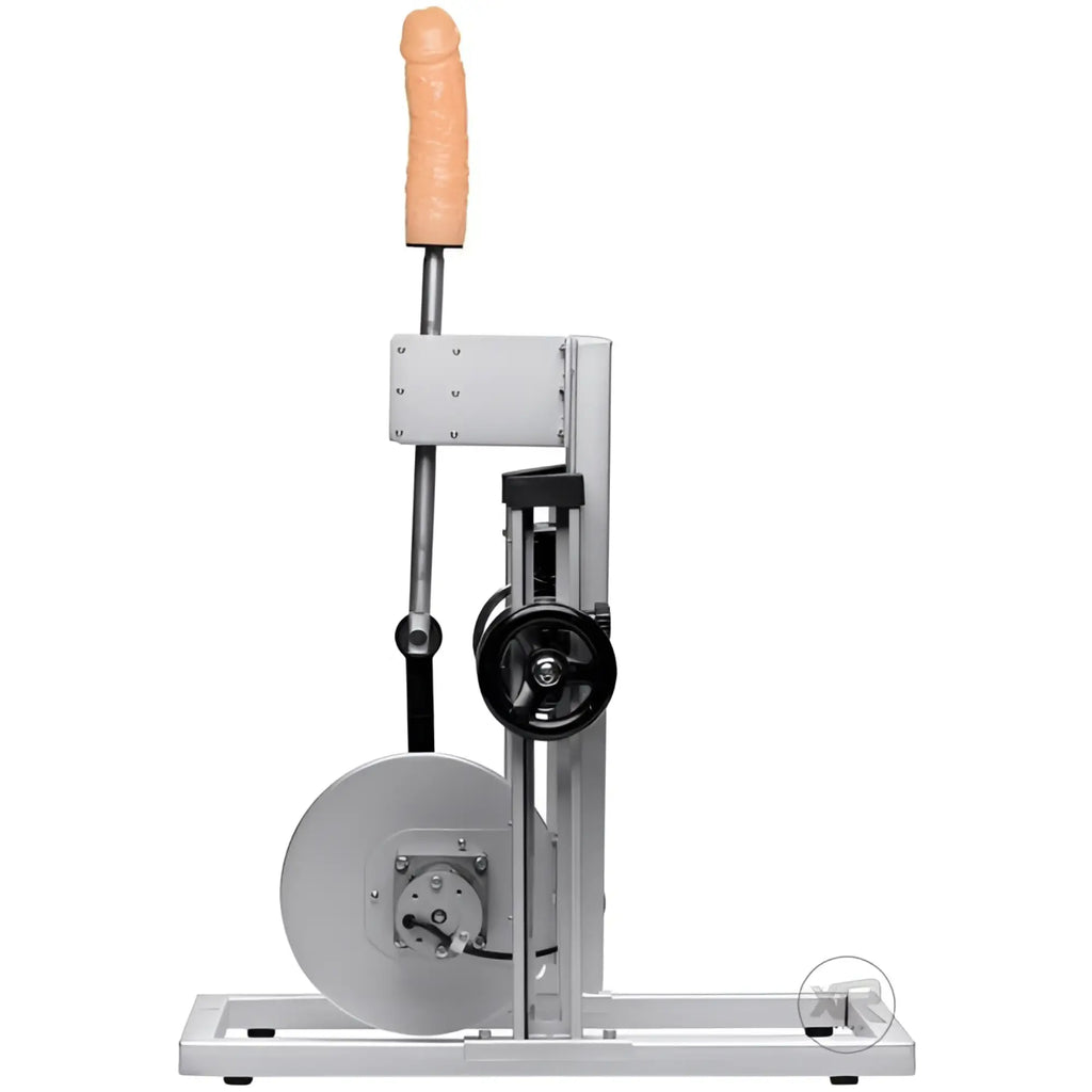 LoveBotz Maestro machine: A silver metal mechanical frame with a vertical tan silicone phallic attachment.
