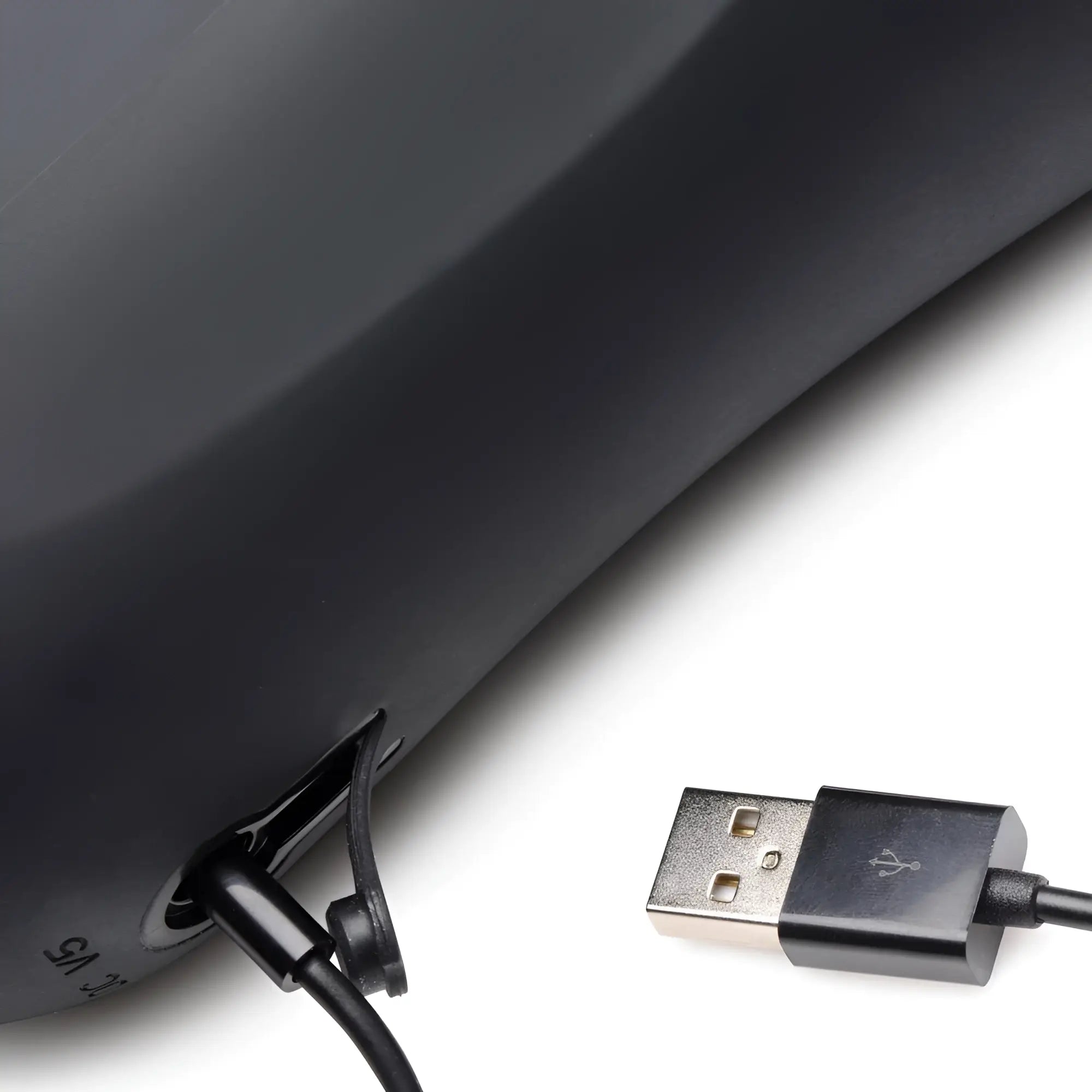LoveBotz The Milker 15X masturbator with matte black finish, showing a connected charging cable against a white backdrop.