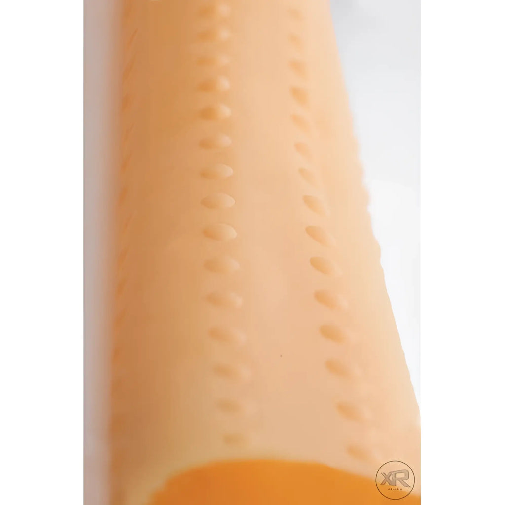 LoveBotz Milker Cylinder: A peach-colored cylindrical sleeve featuring vertical lines of raised, textured bumps.
