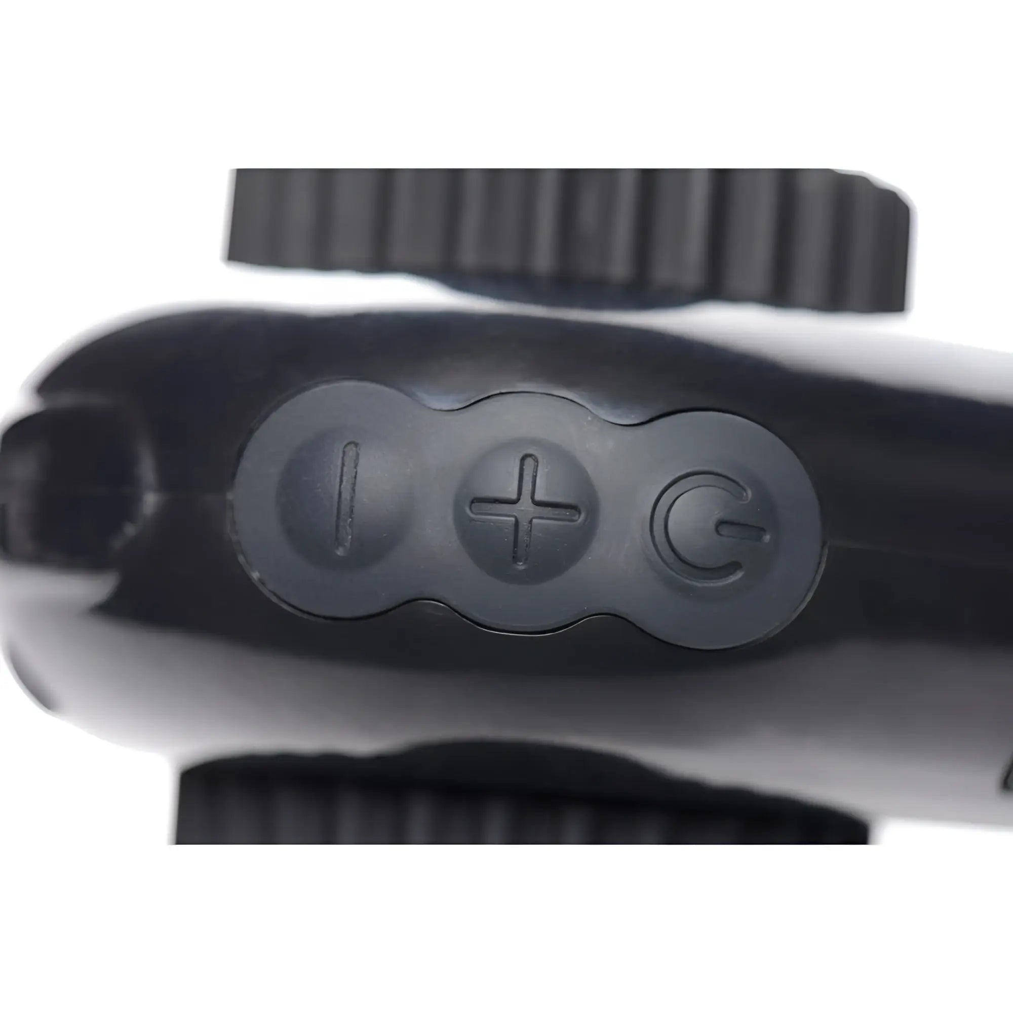 Close-up of the LoveBotz Pro-Bang remote, featuring three black circular control buttons on a smooth, black surface.
