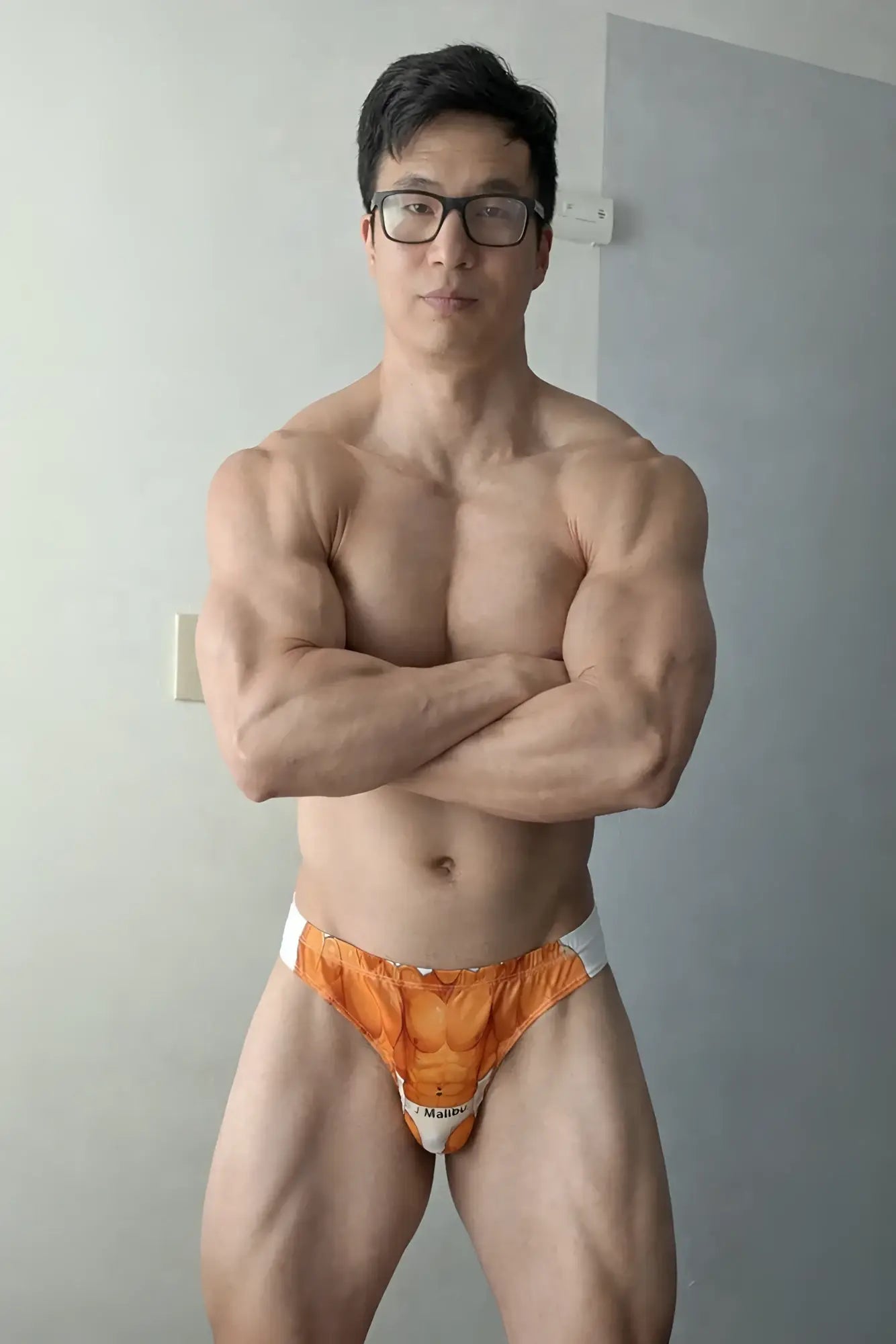 Orange and white Lovesick Briefs anime athletic briefs with printed abdominal muscle design for active wear