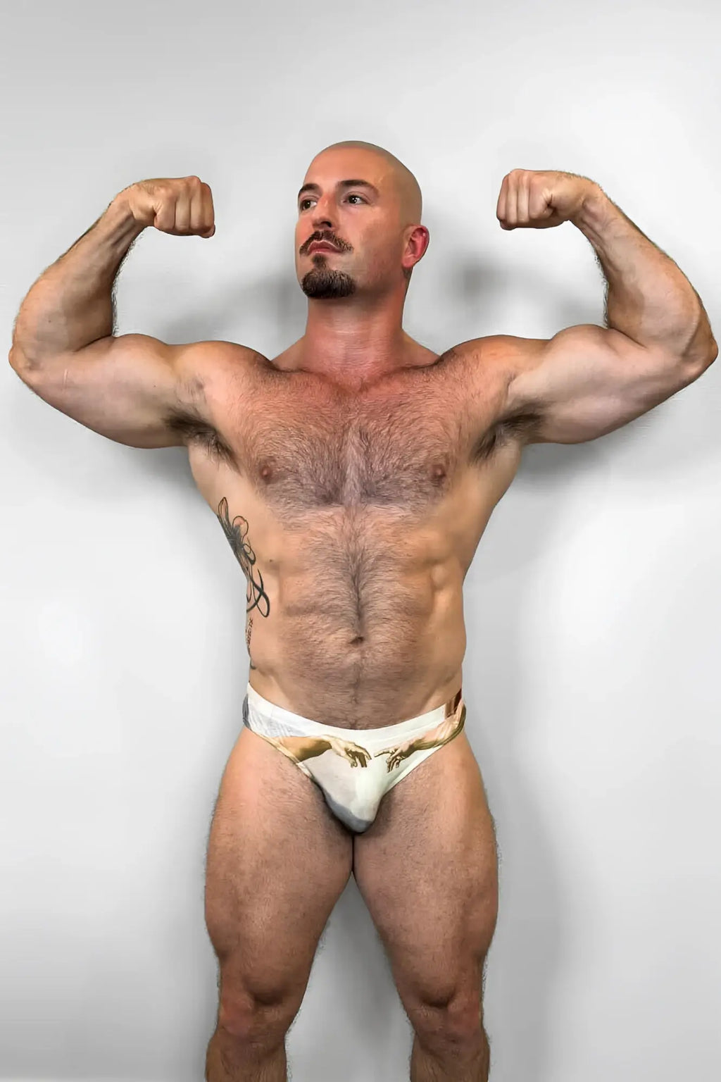 White briefs with a gold and beige creation of adam hands design from lovesick briefs collection