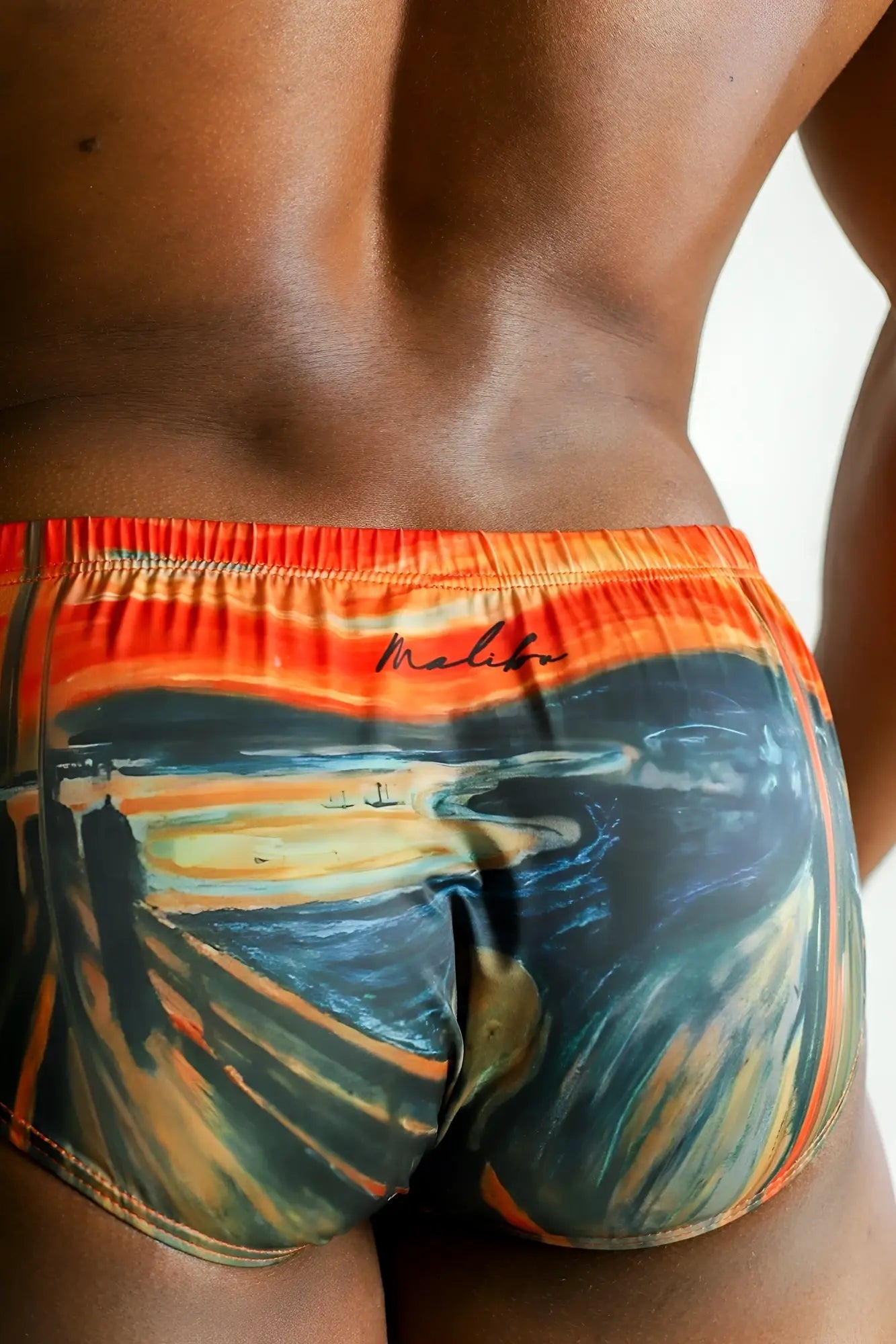 Lovesick briefs scream swim trunks in vibrant orange and deep blue with bold swirling design and meliba logo waistband