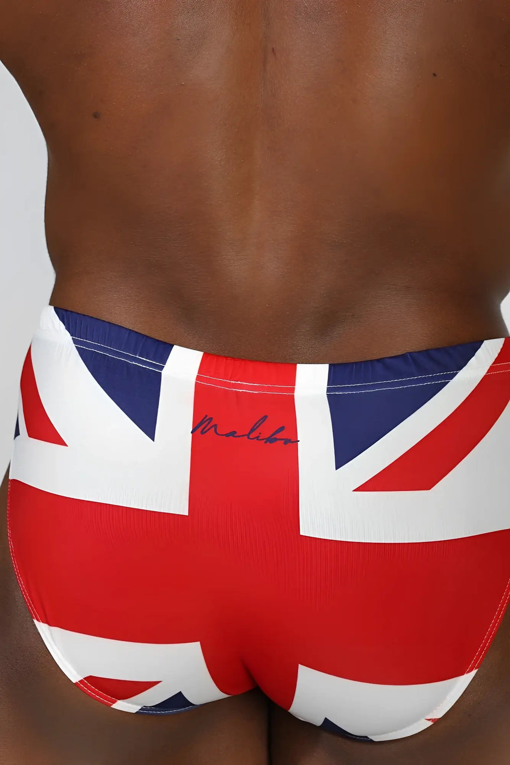 Men’s swim trunks in union jack pattern with red white and blue colors and malibu logo on waistband lovesick briefs