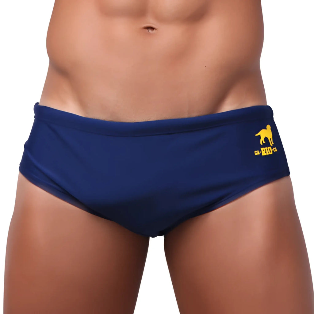 Navy blue low rise solids cut sunga male bathing suit with yellow dog logo and ca-rio text on sideband