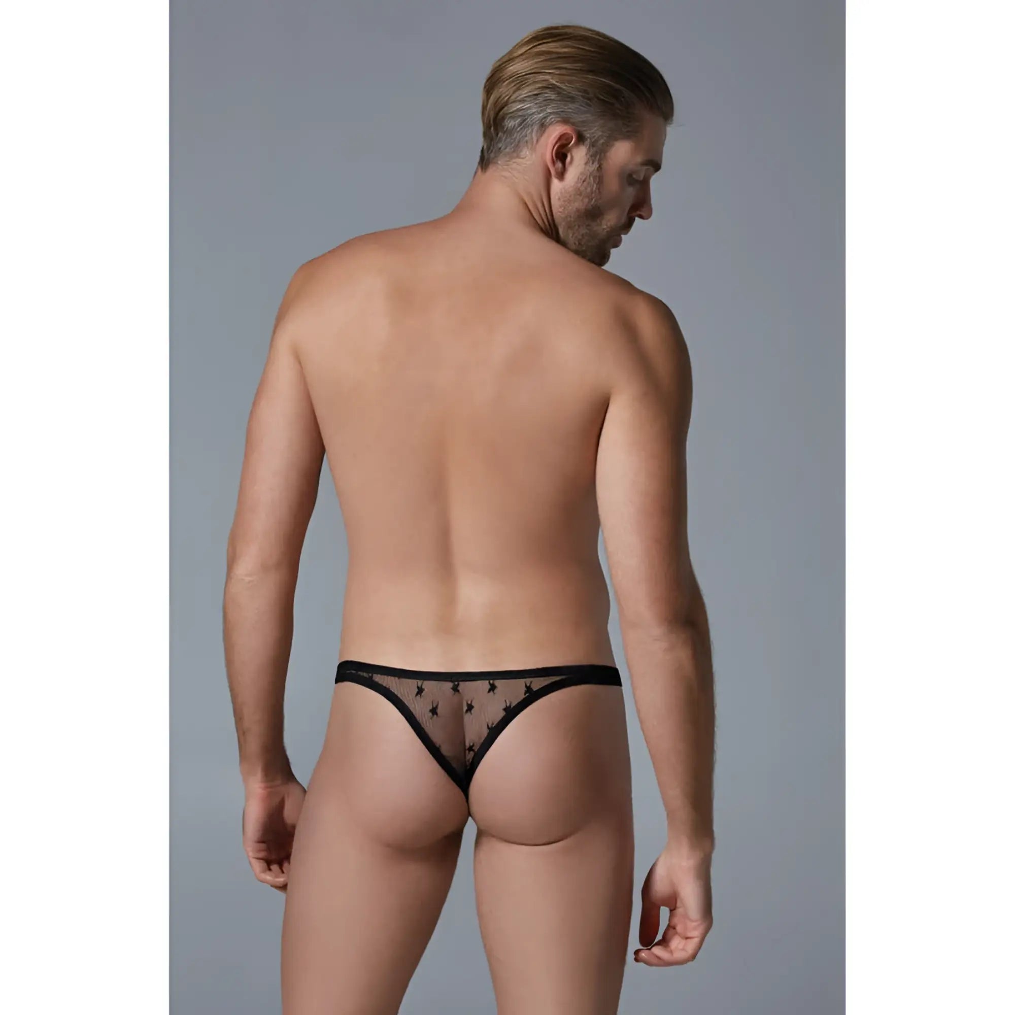 Black sheer lace thong with small star patterns from the luca star men’s sheer thong collection shown from back side
