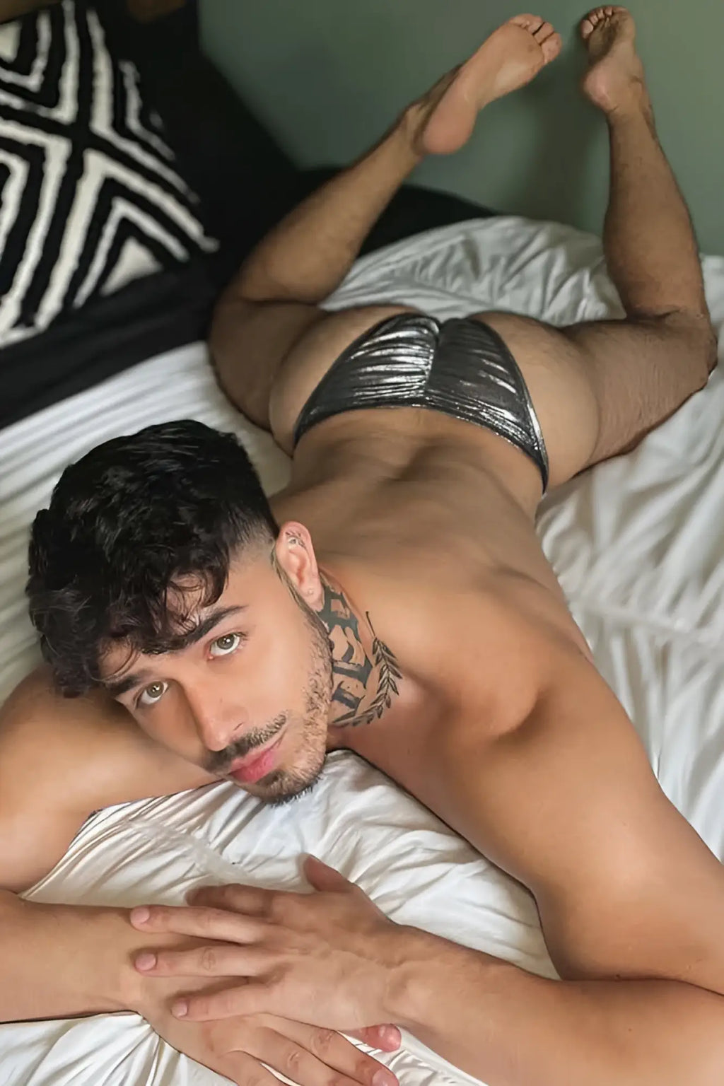 Shiny silver metallic luna scrunch-butt thong with textured reflective surface shown from the back side
