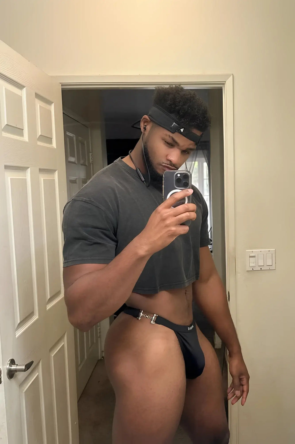 Black athletic g-string swim thong with metallic buckle and brazil logo on waistband in midnight black luster finish