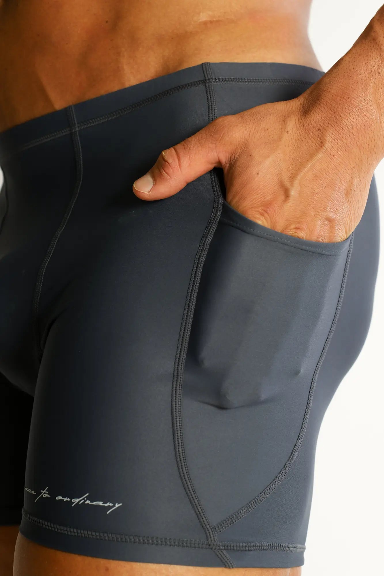 Dark gray lustrous scrunch-butt 4.5 inch bike shorts with side pocket and subtle stitching details in graphite color