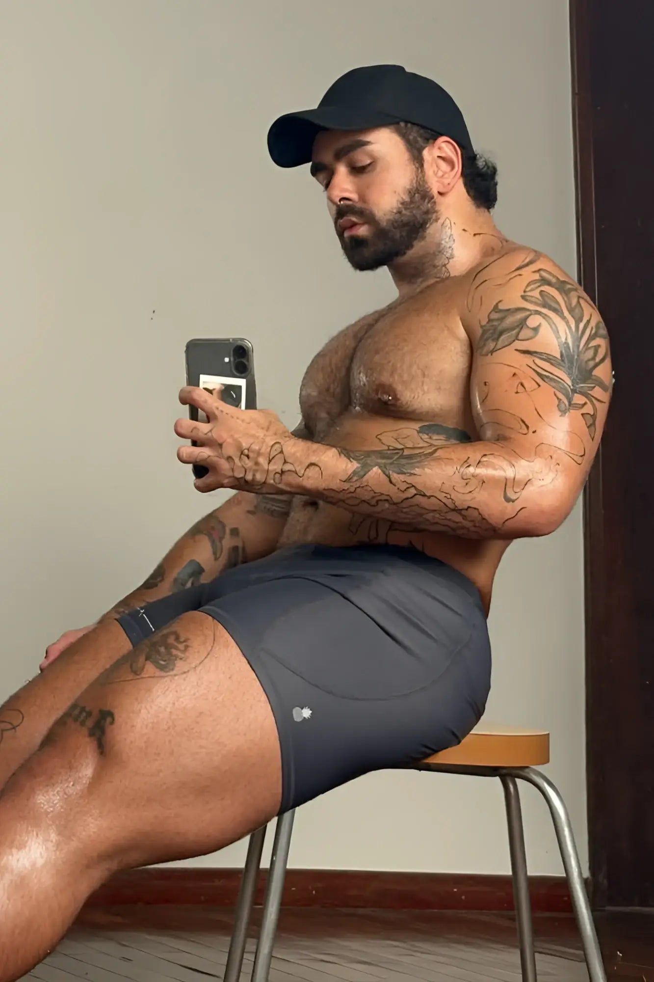 Dark gray lustrous scrunch-butt 4.5 inch bike shorts with a small white logo on the lower right leg