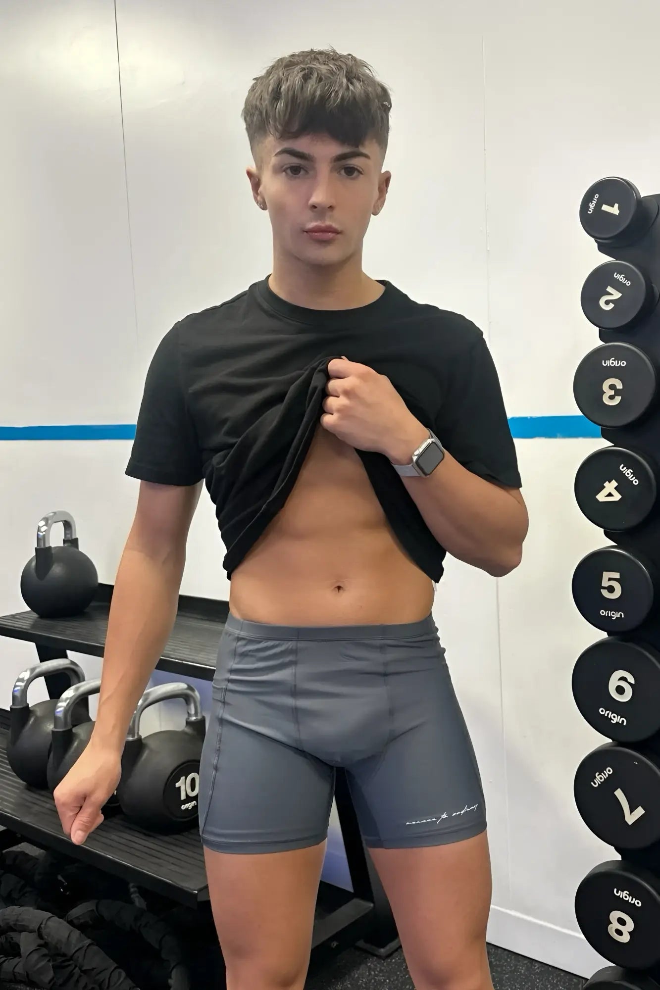 Gray lustrous scrunch-butt 4.5 inch bike shorts with subtle white logo on lower right leg for athletic use