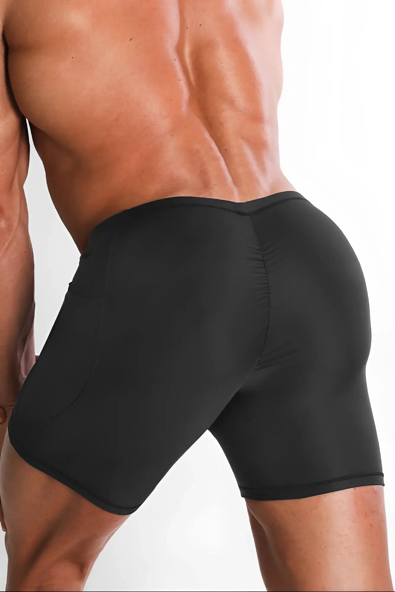 Black form-fitting lustrous scrunch-butt 4.5 inch bike shorts in onyx black with smooth stretchy fabric shown from back