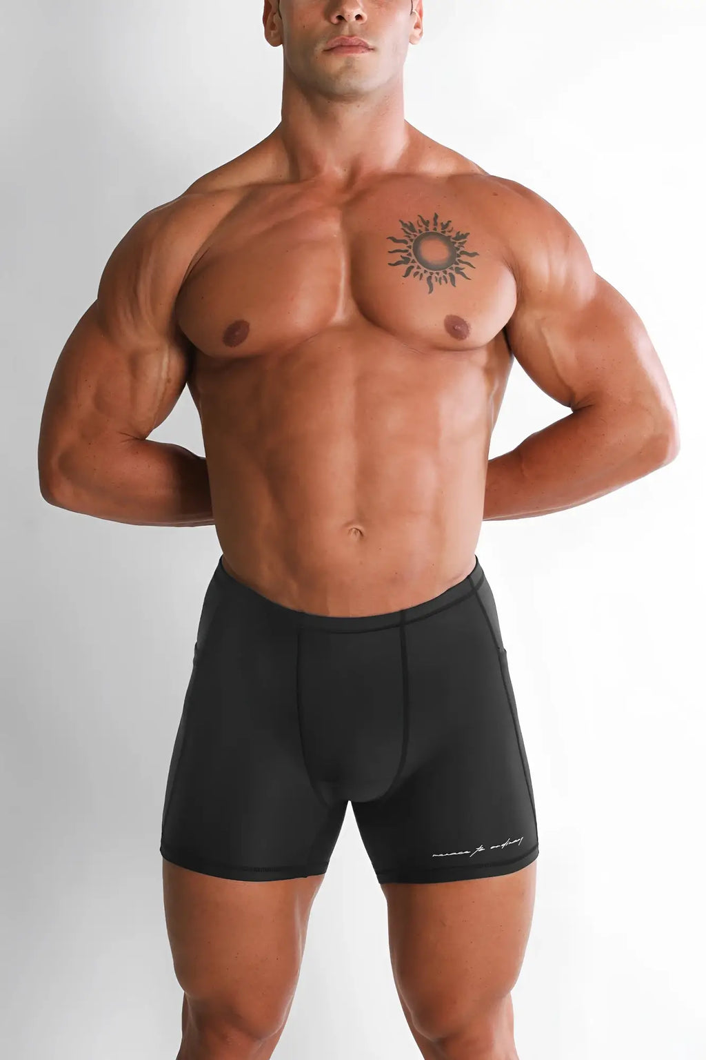 Black athletic lustrous scrunch-butt 4.5 inch bike shorts with subtle white logo on lower right leg in onyx black
