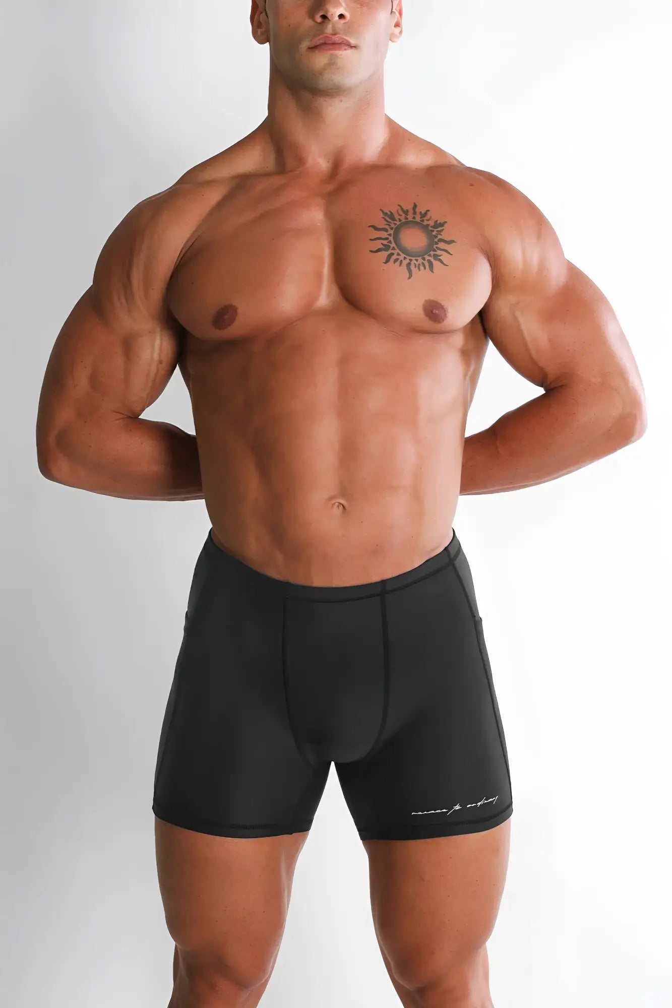 Black athletic lustrous scrunch-butt 4.5 inch bike shorts with subtle white logo on lower right leg in onyx black